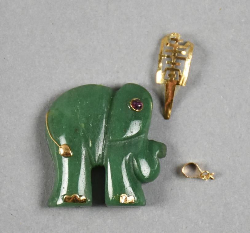 c1960 Chinese 14K Spinach Jade & Ruby Elephant Pendant: This great piece is Chinese jade. Carved elephant with ruby eye with gold feet and tail. The additional piece of gold is the blanket that goes over his back as well as the bale. The bail is stamped 58
