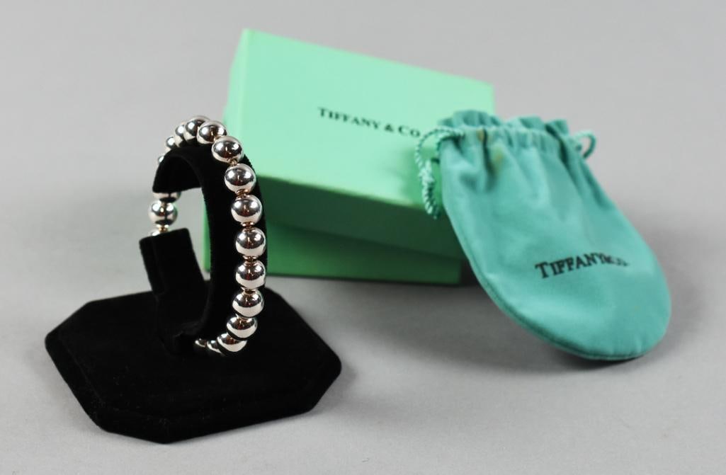 Tiffany & Co Sterling Silver Ball Bracelet w/ Pouch & Box: Great sterling bracelet from Tiffany & Co. Ball beads strung on a rope chain. Lobster clasp with metal tag, stamped 925 on one side and Tiffany & Co. on the other. Comes with the iconic Tiffany pouch