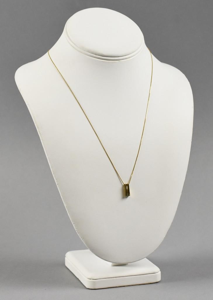 18K Yellow Gold Box Chain w/ Diamond Pendant: Lovely 18K yellow gold necklace made in Italy. Delicate box chain with 10K yellow gold modernist solitaire diamond pendant. Chain is an approx. weight of 1.2 grams and approx. 20" long. Pendant is app