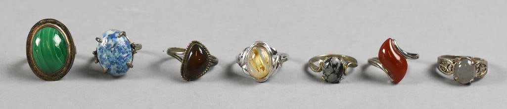 Assort Sterling & Gemstone Rings: Lot is for seven lovely vintage sterling silver rings with semi precious stones. Gemstones appear to be malachite, jasper, carnelian and more. Sizes are approx. 6 to 9.