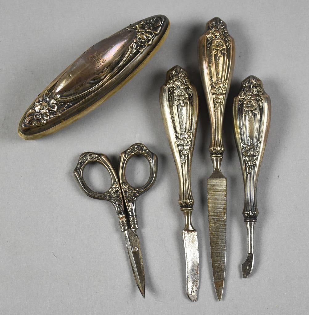Art Nouveau Watrous Sterling Manicure Set: This is a beautiful set of sterling from Watrous. This set has a beautiful floral motif and reeded details. The set includes a buffer, file, scalpel, cuticle tool and a pair of scissors. Scissor