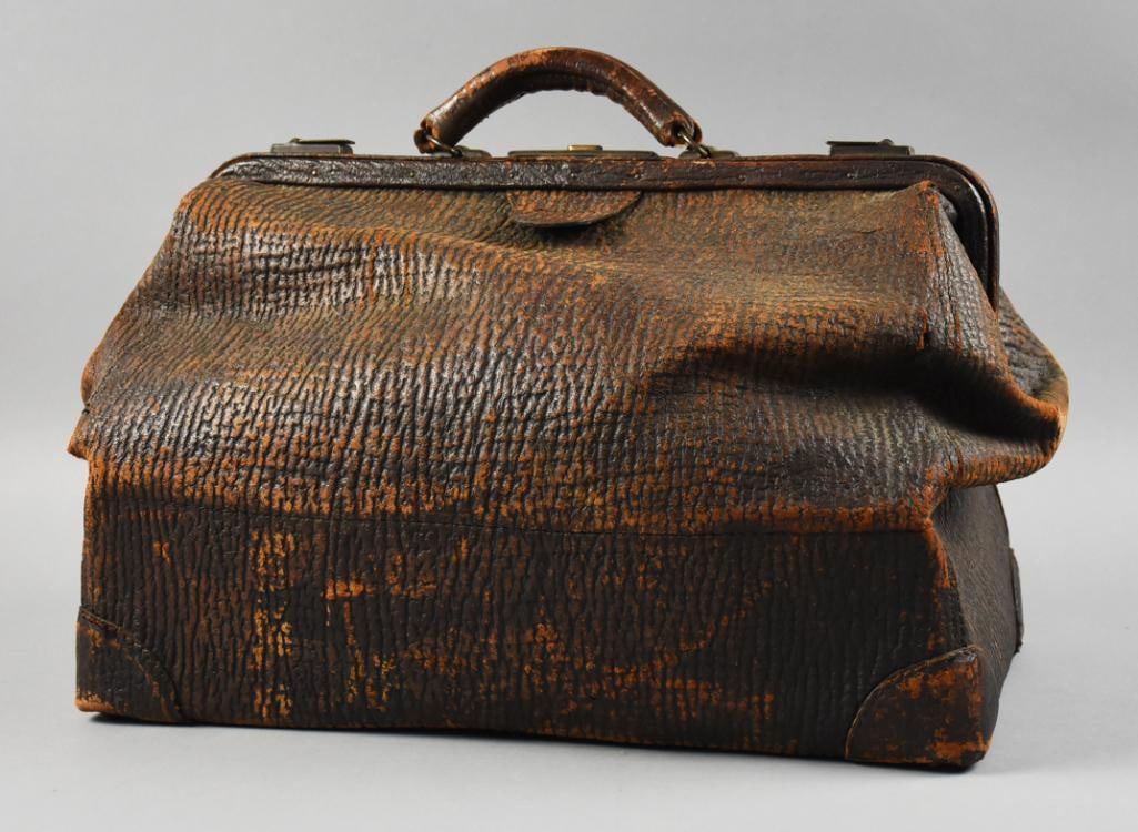 Antique Marbled Leather Doctor Bag: Wonderful antique bag. Doctor bag appears to be from the early 1920s in brown marbled leather with leather handle and brass hardware. Soft tan leather lined with inside pockets, flat on bottom and