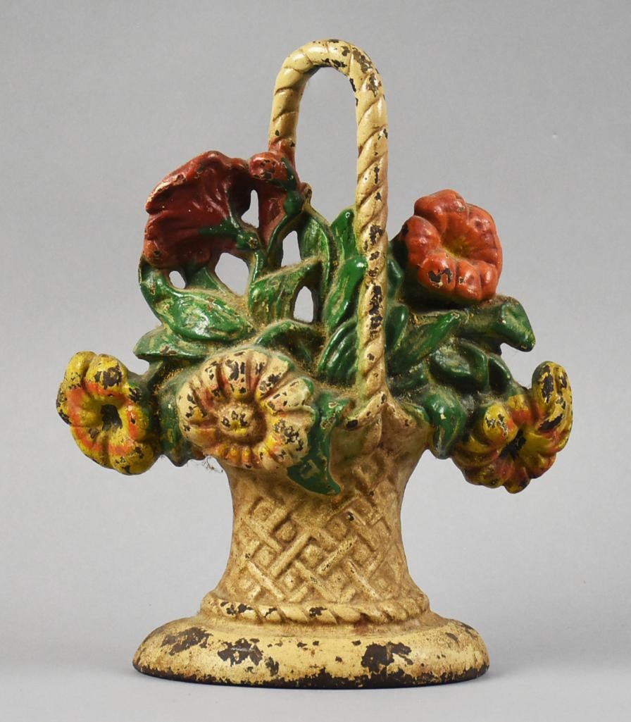 c1925 Hubley Flower Basket Cast Iron Door Stop: Beautiful antique Hubley door stop in cast iron. Basket full of flowers with polychrome painted red, yellow and off white flowers. No visible marks and measures approx. 9.5" x 8".