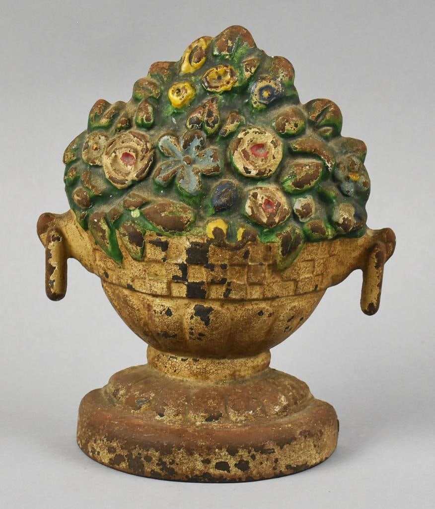 Victorian Cast Iron Flower Urn Door Stop: Wonderful Victorian door stop attributed to Hubley or Bradley & Hubbard. It is a basket style urn with ring handles and painted flowers, paint appears to be polychrome. No visible marks, measures appr