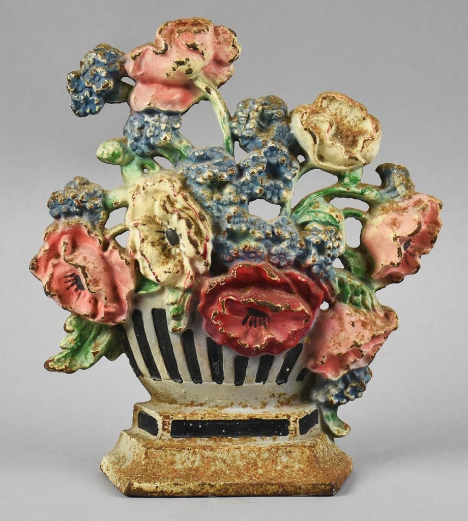 c1925 Hubley Flower Urn Cast Iron Door Stop: This is a stunning antique door stop from Hubley. It is an urn filled with blue, pink, white and red flowers. Polychrome paint, no visible marks. Measures approx. 7.5" x 7".