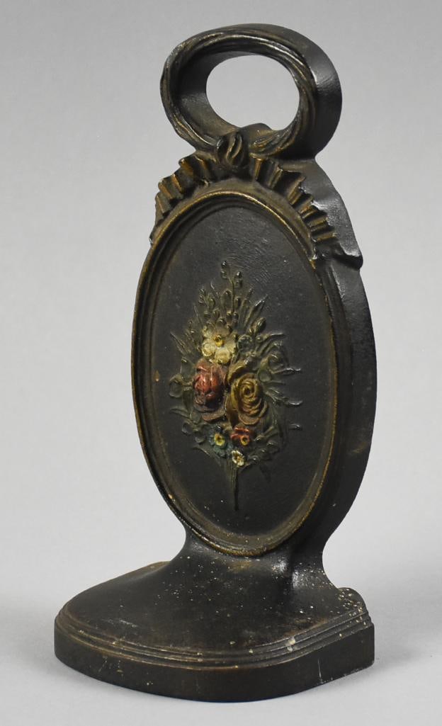 Antique Bradley & Hubbard Cast Iron Floral Doorstop: This is a gorgeous cast iron doorstop from Bradley & Hubbard. Oval medallion with flower bouquet in center. Marked B&H on back. Measures approx. 7.5" x 4".
