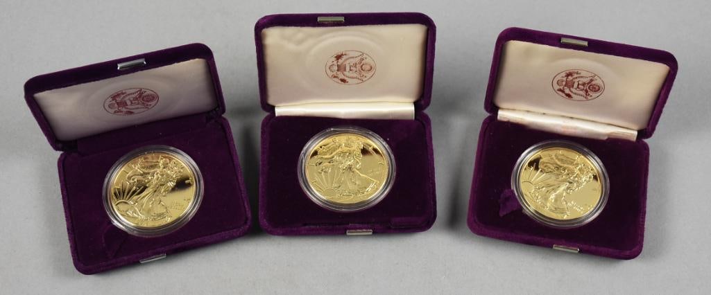 2015, 2016 American Silver Eagles, 24K Gold Clad: Lot is three American Eagles, Silver and gold clad, appears to be 24K. Dates are 2015 and two 2016. Come in the original presentation boxes.