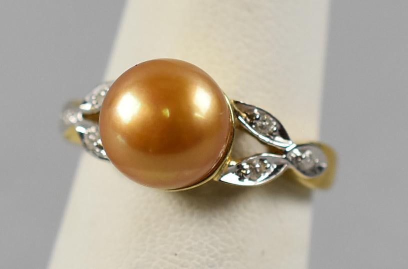 14K Yellow Gold Sunset Pearl and Diamond Ring: This stunning ring is 14K yellow gold. Set with a golden pearl, identified on the tag as a Sunset Pearl, flanked by six round cut diamonds-three on each side set in white gold. Overall approx. weight