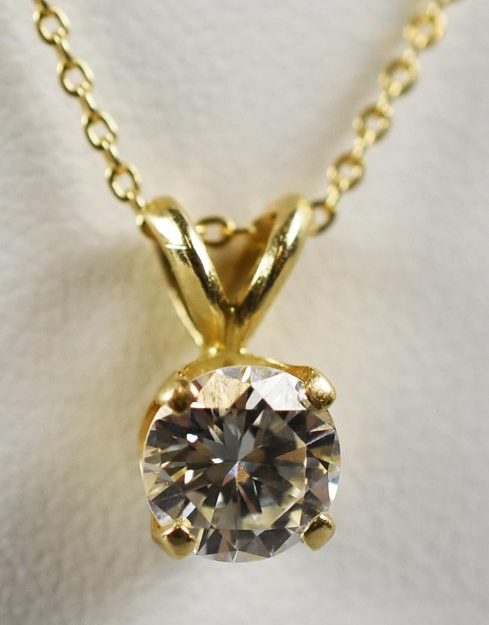 14K .85 Ct Solitaire Diamond Pendant Necklace w/ Appraisal: Beautiful 14K solitaire diamond pendant on a 14K gold snake chain. Diamond is approx. .85 carat modern round cut, It hangs from a 14K cable chain that measures approx. 16" long. Overall approx.