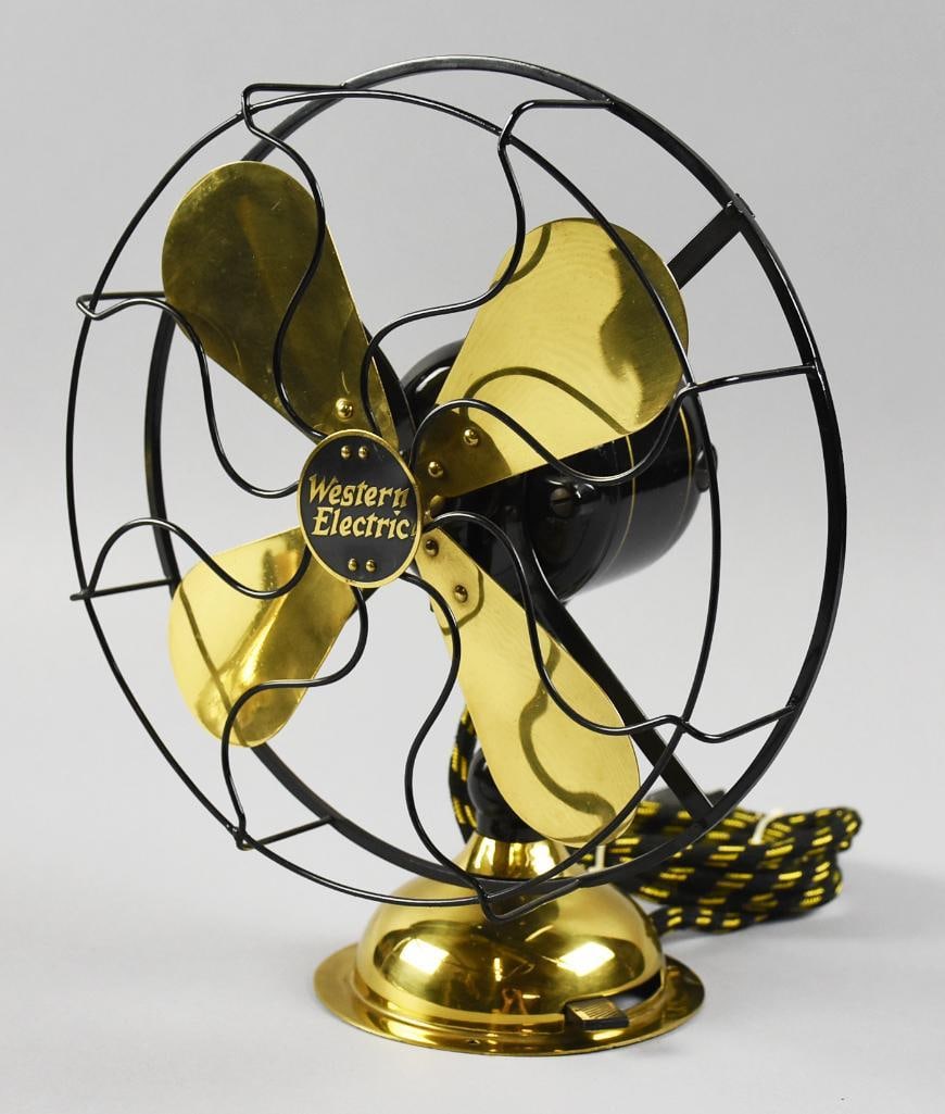 Antique Western Electric Alternating Current Table Fan: Beautiful and fully restored antique fan from Western Electric which appears in a 1923 catalog. Fan with brass blades and cage appears to be bent steel. Heavy cast motor, base appears cast with brass