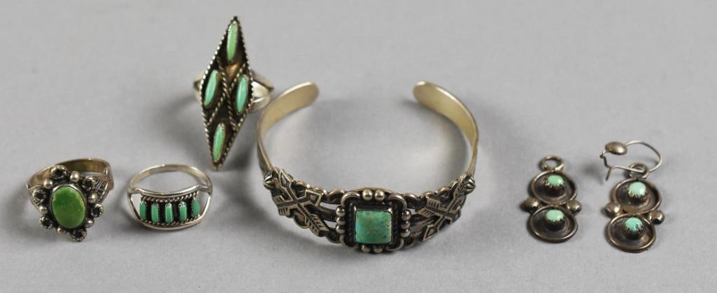 Vintage Native American Sterling Turquoise Jewelry: Stunning sterling silver Native American jewelry. Includes both Zuni and Navajo with three rings, cuff bracelet with crossed arrow design and pair of dangle earrings.