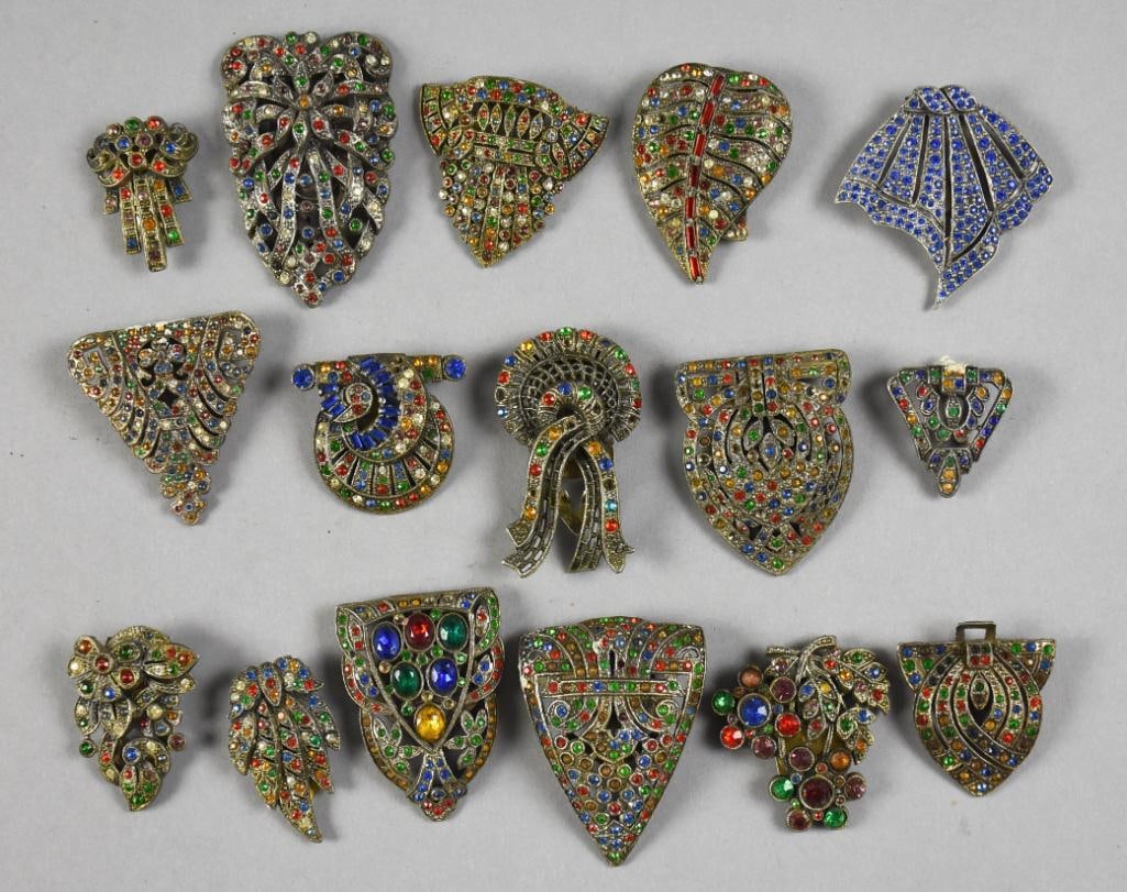 c1930 Art Deco Rhinestone Fur Clip Assortment: There are 16 individual fur clips from the 1930s to early 1940s. Each appears to be made of pot metal and encrusted with multi color rhinestones. Some with very ornate clips on back. No visible marks,