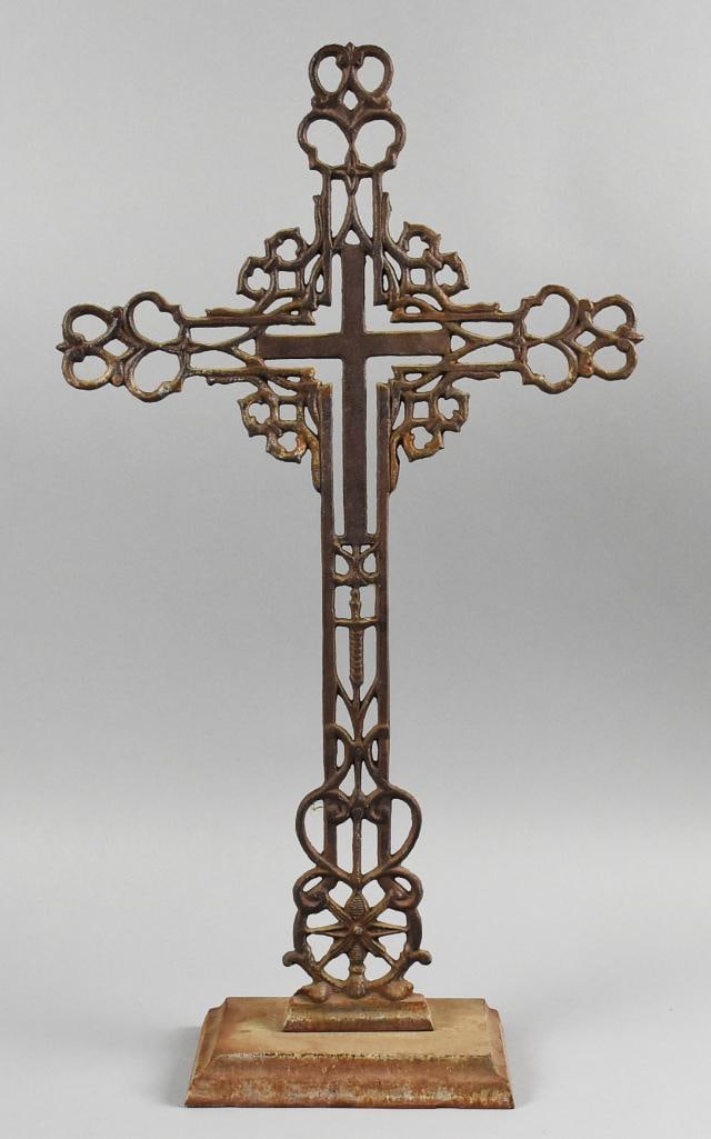 Antique Wrought Iron Standing Cross Sculpture: This gorgeous cross appears hand crafted. It appears hand wrought with pretzel type shapes, heart, star and solid center cross. Stands on a rectangular base and measures approx. 27" tall x 15".