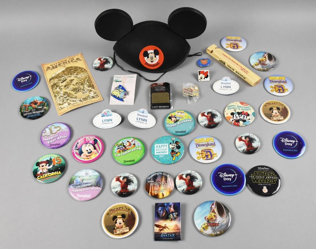Large Assortment Disneyland Pinbacks & More: Here's a fun lot of Disneyland collectibles. Mostly pinbacks such as Happily Ever After, Star Wars, Disney Day, Little Mermaid and more. Lynn name badges, trade pins, wooden train whistle, Rivers of A