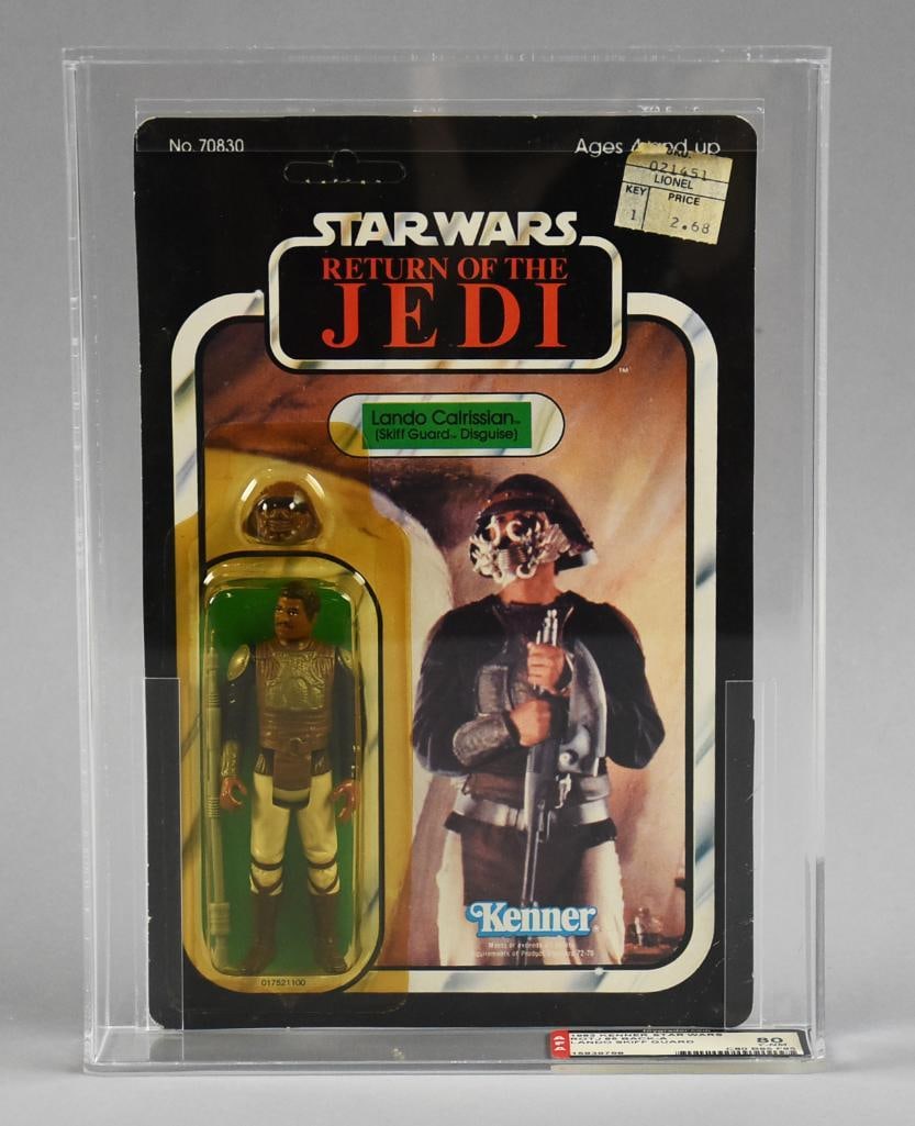 1983 Kenner Star Wars Lando Skiff Guard 65A Back 80 Y-NM: Lot is for a Kenner Star Wars Lando Skiff Guard action figure from 1983 on a 65A card back. It has been graded by Action Figure Authority - AFA.