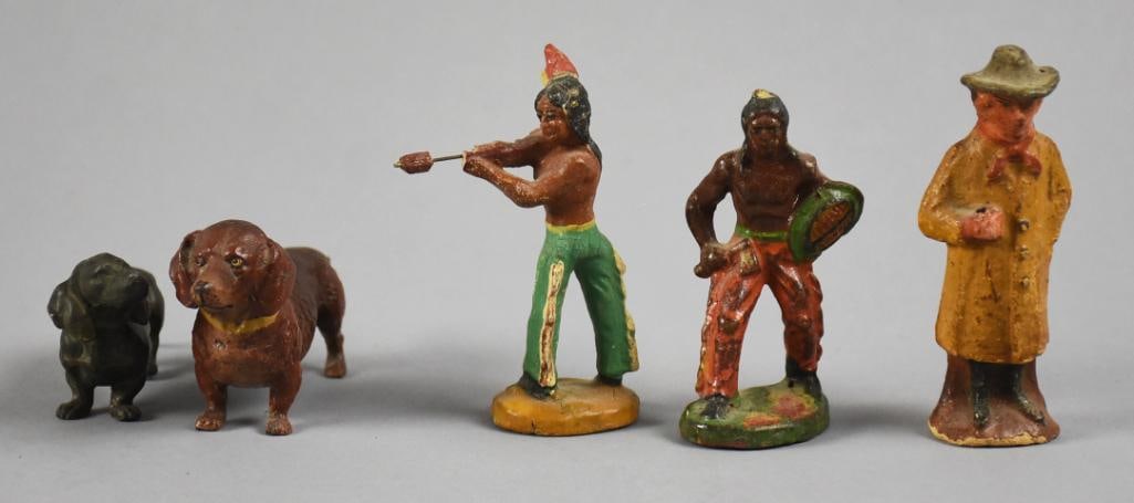 Vintage Assorted Toy Figurines: Lot is various figurines including two Native Americans, two Dachshund dogs and a man in a yellow coat. No visible marks and measure from approx. 1.5" to 3.5" tall.?