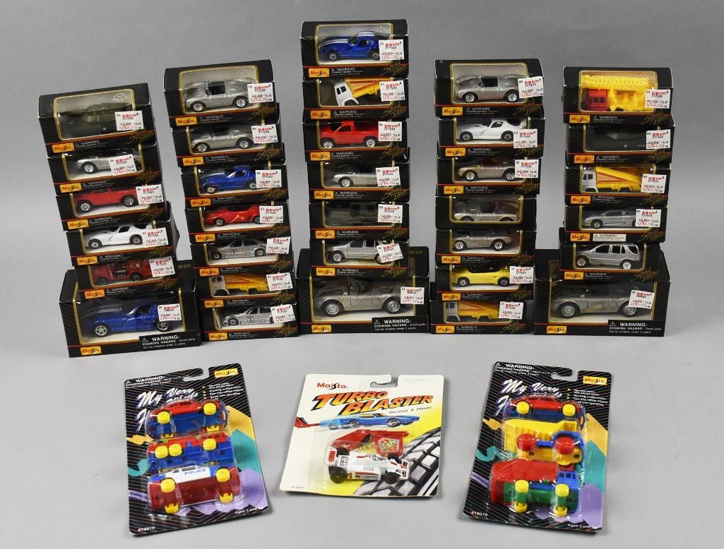 (35) 1994, 97 Maisto Die Cast and Plastic Cars-MOC-NOS: Lot is 35 1994, 97 Maisto Die Cast and Plastic Cars-MOC-NOS.Lot including but not limited to two My Very First Wheels with three cars each, Turbo Blaster, Porsche, Dodge Dakota, Mercedes and more.