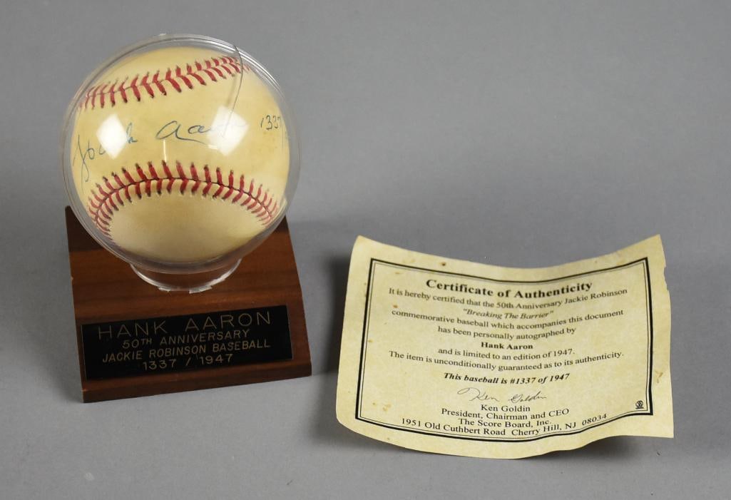 Hank Aaron Signed Baseball for Jackie Robinson Commemoration: This awesome ball was signed by Hank Aaron in commemoration of Jackie Robinson's 50th anniversary of "Breaking the Barrier". Comes with COA from The Score Board, Inc. and is a limited edition 1337 of