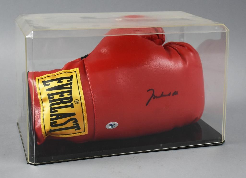 Muhammad Ali Signed Everlast Boxing Glove in Case w/ COA: Wonderful vintage boxing glove signed by "The Greatest", Muhammad Ali. It is an Everlast, signed in black ink, possibly sharpie. Comes the case and shown and includes a Universal Sports Authority