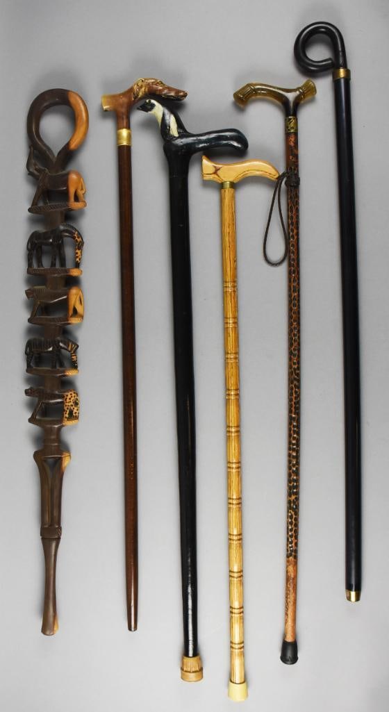 Vintage & Antique Walking Stick Assortment: Very fun collection of vintage and antique walking sticks. These include one with loop handle and multiple wild animals carved into the shaft, one loop handle is metal, carved handle that appears