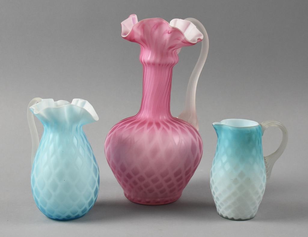 Victorian Mt. Washington Diamond Quilted Satin Glass: Gorgeous lot of quilted satin glass attributed the Mt. Washington. Includes two blue small pitchers, one with ruffle rim and tall pink pitcher with ruffles. All with pulled satin glass applied handles