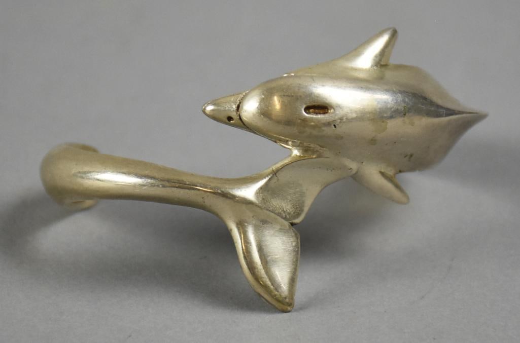Sterling Dolphin Cuff Bracelet Mexico D. Ramirez: Whimsical stylized sterling bracelet from Mexico. It is Taxco silver in the form of a dolphin with the upper half and tail meeting in the middle. It is nicely marked inside the dolphin tail. Signed by