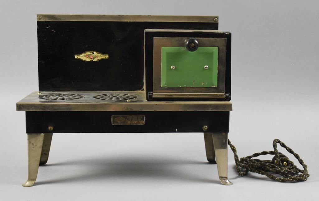Vintage Metal Ware Corp Empire Child Toy Stove: Very cute vintage Empire child toy stove from Metal Ware Corp. c1940 pressed steel stove black and green with two burners and small oven and pretty floral decal. Cloth cord appears original. Measures