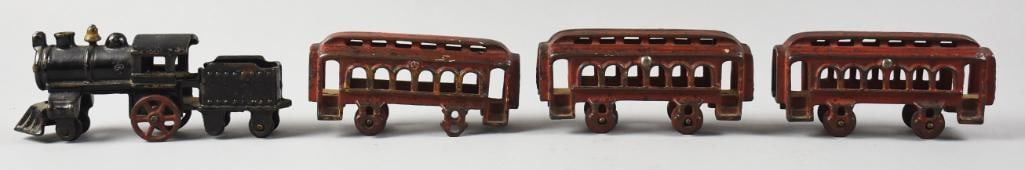 Antique AC Williams Locomotive & Train Cars, Cast Iron: Great antique train set attributed to AC Williams. This lot includes a locomotive with coal tender - all one piece - and three passenger cars. All are in cast iron and hand painted. Passenger cars