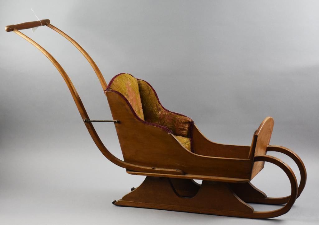 Victorian Child or Doll Sleigh, Brocade Cushion Seat: Beautiful Victorian child or doll sleigh of solid wood.? Brocade rose pattern on padded seat and back that also lines the floor. Burgundy? accent trim along arms and around back, appear satin. Solid w