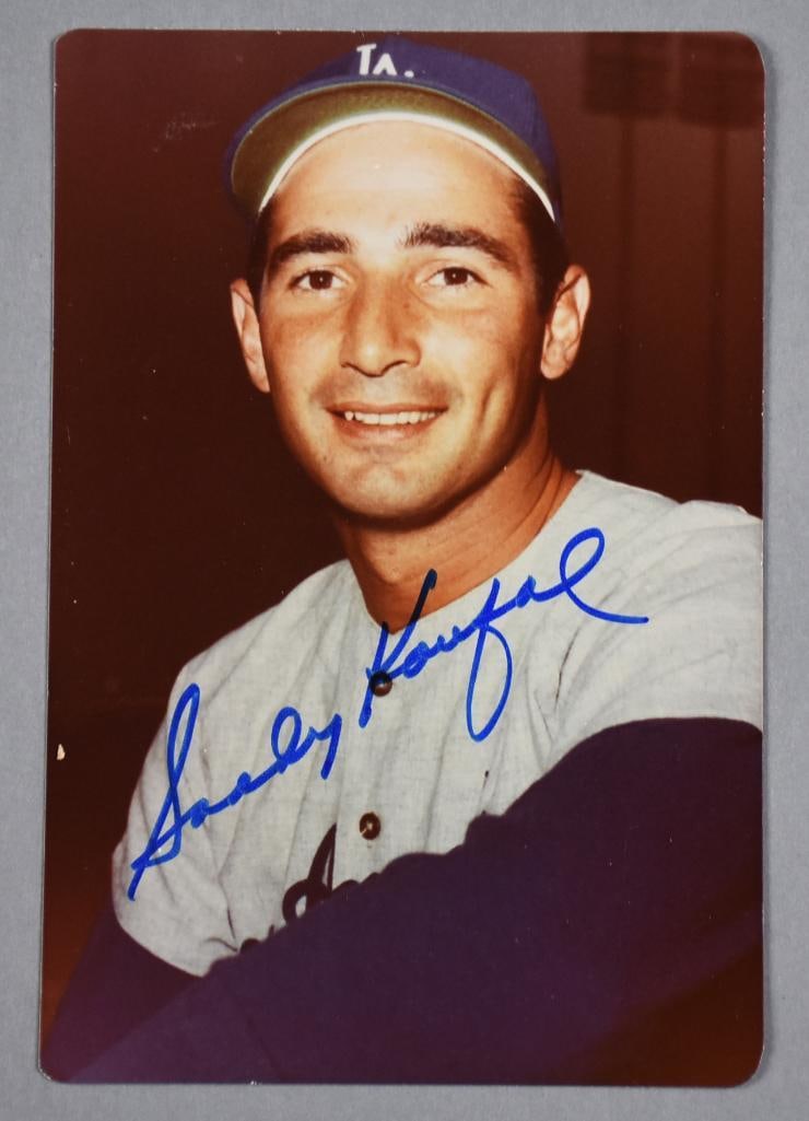 Sandy Koufax Los Angeles Dodgers Signed 4" x 6" Glossy Photo: Sandy Koufax Signed Los Angeles Dodgers Photo This is a color photo of Sandy Koufax in a Los Angeles Dodgers uniform, signed boldly in blue marker across the front. The photo/card has rounded corners