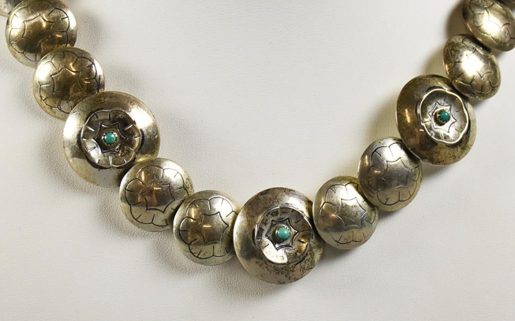 Vintage Navajo Sterling Stamped Pillow Bead Turquoise Necklace: This wonderful necklace is Navajo and sterling. Each pillow bead appears hand stamped with the center bead having a concave stamp with round turquoise stone. No visible signatures and measures approx.