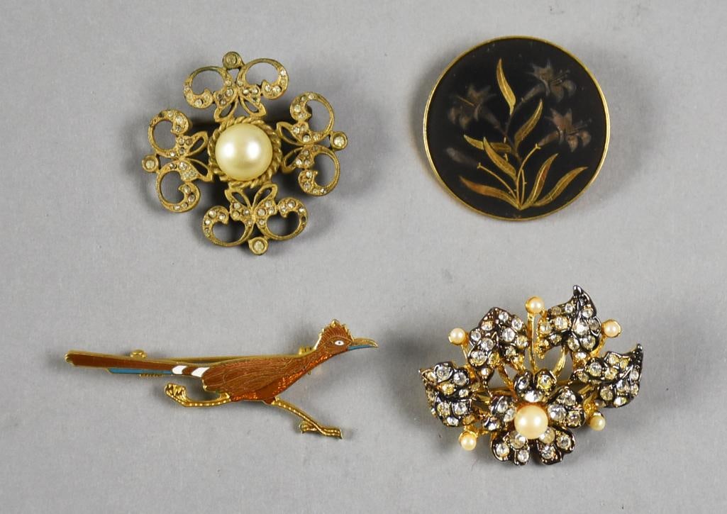 Assorted Vintage Costume Jewelry Brooches: These are sweet vintage brooches and they are costume. Includes a signed Cadoro in a Victorian style, round damascene with crown mark and two unmarked: roadrunner and rhinestone with faux pearls.