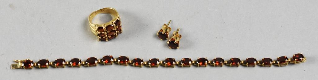 Vintage 10K K& 14K Yellow Gold & Garnet Jewelry Set: Beautiful gold and garnet jewelry set. It includes a 10K tennis style bracelet with 18 faceted garnet, stamped on the closure, measures approx. 7". The wide band ring with 9 faceted garnet, stamped in