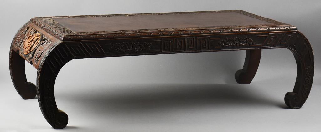 Antique Chinese Carved Rosewood Kang Opium Table: Beautiful antique Chinese table that appears rosewood. It is an expertly carved opium bed table. Smooth top with ornate meander carvings along top edges and sides and floral bunches. Each end is deepl