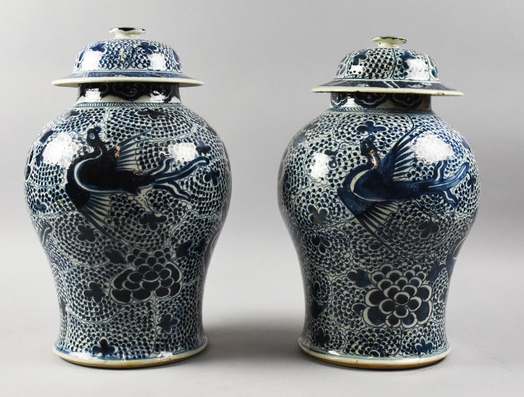 19th Century Chinese Export Blue & White Vases w/ Covers: Gorgeous pair of Chinese exports from the late 19th century. This pair of vases with covers are porcelain with dark blue flying Phoenix amongst peonies. No visible marks, stand approx. 16" tall.