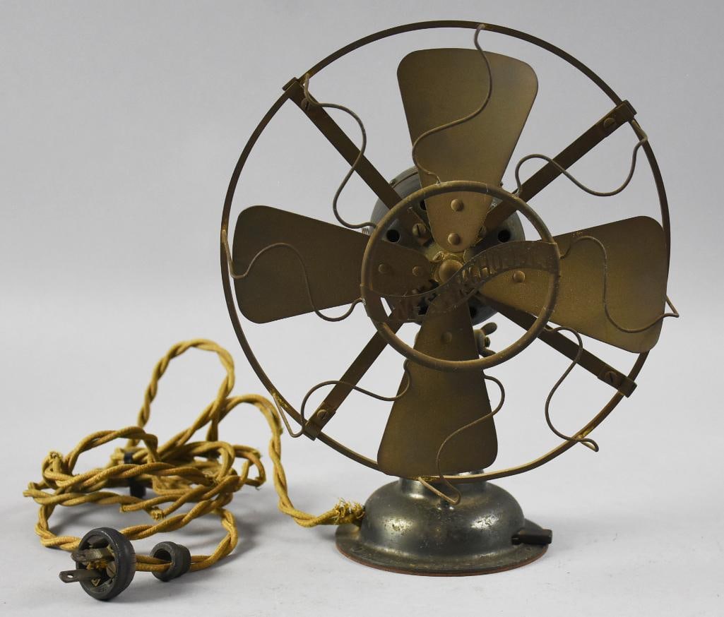 Antique Westinghouse Electric Mfg Co Table Fan: Very cool antique fan from Westinghouse Electric Mfg Co. Tabletop fan with what appears to be a brass cage with brass blades. Manufacturer log on front. Base appears cast iron, retains original brass 