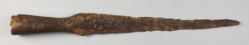 12th Century Bronze Spearhead, Recovered from Bog: This ancient socketed spearhead was recovered from a bog. It is from the 12th century and appears bronze. Blade is long with hollow end for mounting on a wooden type shaft. Measures approx. 16.5" long