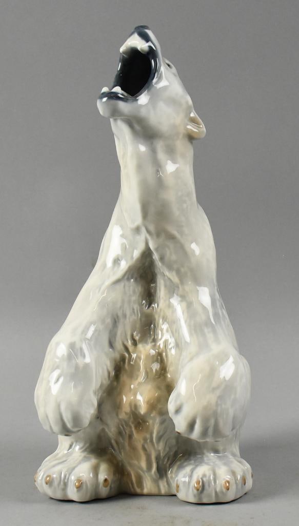 Large Royal Copenhagen Roaring Polar Bear: Very cool porcelain figurine from Royal Copenhagen. It is a sitting roaring polar bear and is well marked on bottom. Stands approx. 12.5" tall.