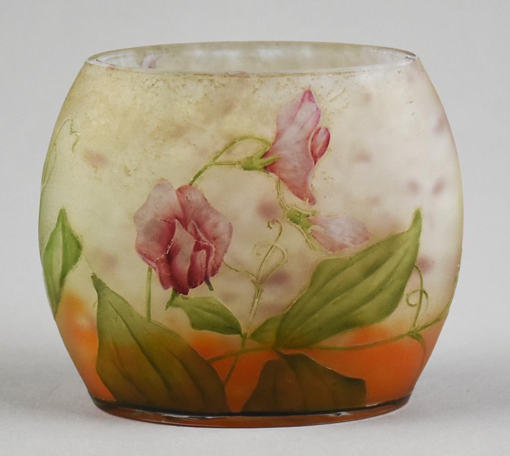 c1900 Daum Nancy Floral Cameo Glass Pillow Vase: This gorgeous art nouveau vase is Daum Nancy in the pillow shape. Cameo glass with sweet pea blossom flowers and large green leaves. Frosted background white to orange. Signed on one side along with