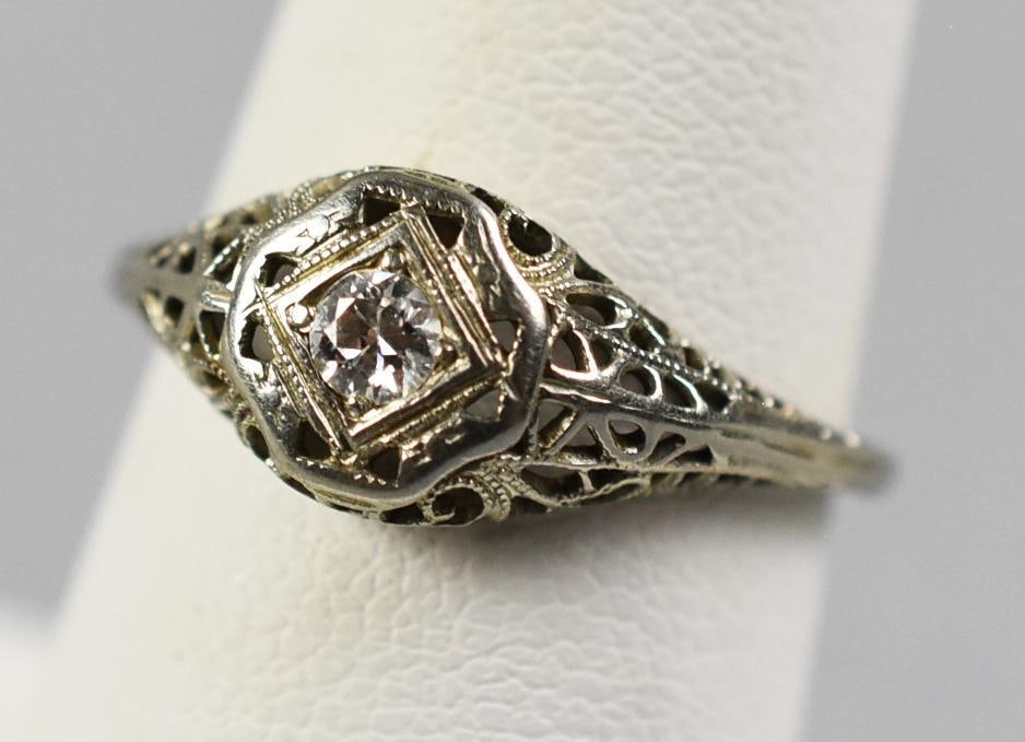 c1930 Art Deco 14K White Gold, Diamond Filigree Ring: This fabulous ring is Art Deco from the 1930s. Filigree design is set with a 3/16 carat diamond. Open work details carry about half way down the sides of the band. No visible marks, approx. weight of