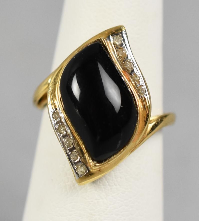 14K Yellow Gold & Onyx & Diamond Ring: Beautiful vintage ring in 14K yellow gold. Set with a freeform polished onyx, flanked by five clear stones that appear to be diamonds. Stamped 14K with no other visible marks. Size is an approx. 5,