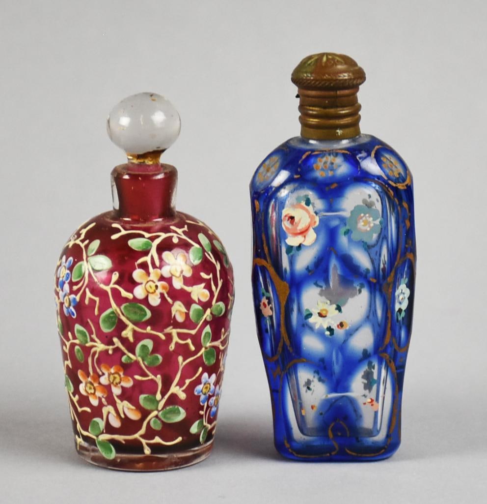 Victorian Cased Glass & Hand Painted Enamel Perfume Bottles: Great looking pair of antique perfume bottles. From the Victorian era, they are cased, one cranberry glass with hand painted enamel white flowers with green leaves and a blue glass with hand painted
