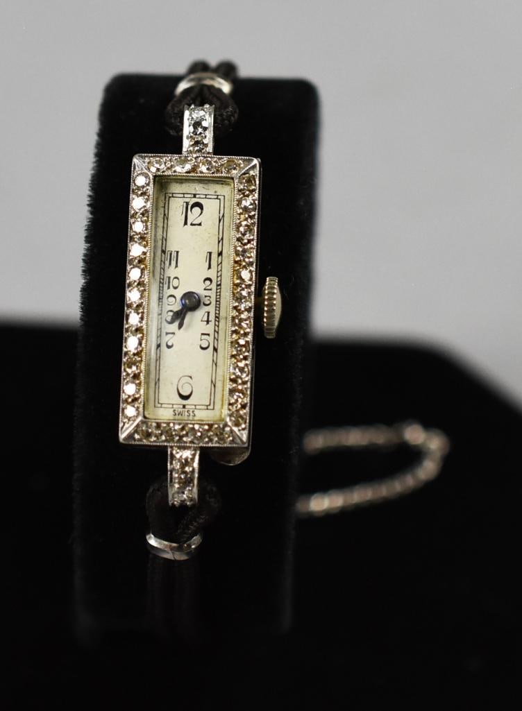 Art Deco Platinum Diamond Adams Ladies Watch: This gorgeous ladies Swiss watch is in a platinum case. Adams Watch, Inc. is stamped on the 17 jewel movement. Case is adorned with over 30 round cut diamonds and stamped inside 900 plat 100 Irid.?