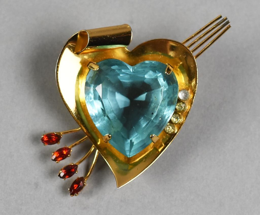 Vintage Coro Sterling Vermeil Aqua Stone Heart Brooch: Wonderful vintage Coro brooch in sterling silver. It is gold over sterling or vermeil. Aqua colored center stone, possibly glass, stylized arrow with red stone feathers. Stamped on back.?