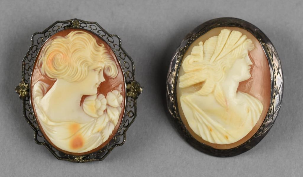 Antique Pair Hard Shell Sterling Cameo Brooches: Stunning pair of hard shell cameo brooches with sterling silver frames. Each appears to be hand carved, one appears to be a Goddess and one is a glamorous woman. Both profile images. No visible marks.