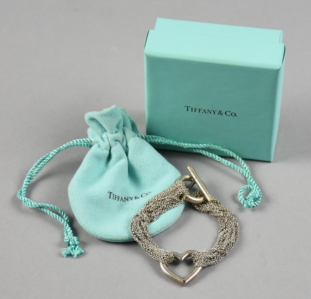 Tiffany Sterling Heart Multi Chain Bracelet Original Pouch, Box: Beautiful Tiffany & Co sterling bracelet with original pouch and box. It has a multiple chains with center heart. Toggle clasp is stamped Tiffany & Co 925.