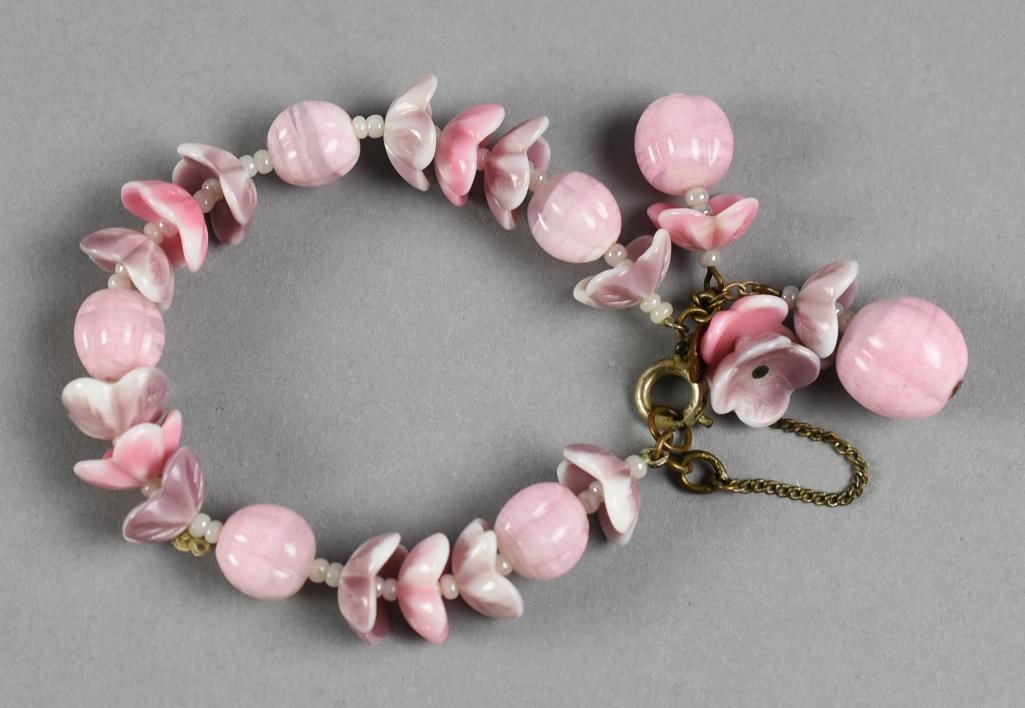 Miriam Haskell Pink Glass Flower Bracelet Vintage: Darling vintage bracelet from jewelry designer Miriam Haskell. It is a pink flower with flowers made of glass and textured round beads. Designer tag near spring clasp.