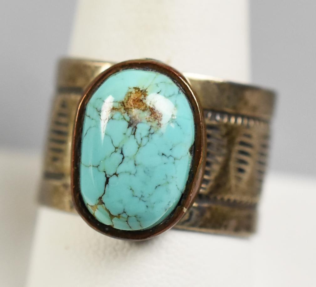 Vintage Native American Sterling, Turquoise Ring: Wonderful ring in sterling silver. Native American with a wide band with stamped diamonds. Center is an oval polished turquoise. Stamped STERLING inside band, no other visible marks. Size approx. 11.