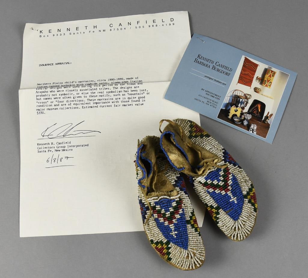 c1885 Northern Plains Indians Childs Beaded Moccasins: Darling pair of child's moccasins from the Northern Plains Indians. Information from the 1987 appraisal indicate they are tanned buckskin, Italian glass beads sewn with sinew and rawhide soles. Beads 