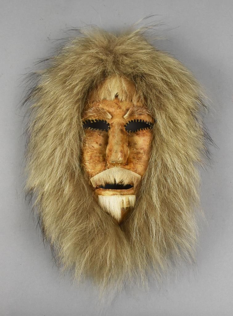 Sadie Nukapigak (1924-1994) Nunamiut Mask: This wonderful piece is from Eskimo artist Sadie Nukapigak (1924-1994). He is believed to be?Nunamiut, appears to be carved wood, covered in what is likely caribou and trimmed in real fur with real fu